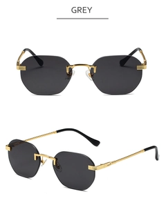 Detail view of grey rimless sunglasses featuring hexagonal lenses and gold twisted temples