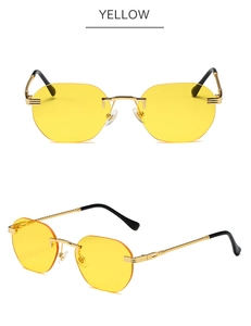 Close-up of yellow octagonal rimless sunglasses with engraved gold metal temples