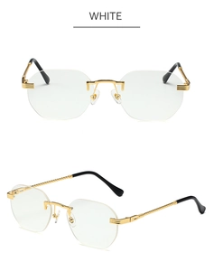 Detail view of gold rimless sunglasses featuring textured temples and clear white lenses