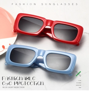 Close-up of trendy oversized square sunglasses in bright red and light blue colors