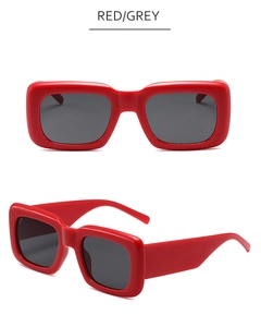 Detail view of red square frame sunglasses with grey lenses and thick fashion temples
