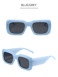 Detail view of retro square sky blue sunglasses with wide temples and grey lenses