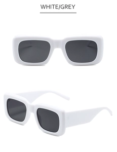 Detail view of white rectangular sunglasses with wide temples and dark grey lenses