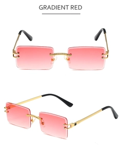 Detail view of rimless gradient red sunglasses with gold metal temples and black tips