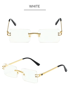 Detail view of white rimless rectangle sunglasses with gold metal frame and engraved arms