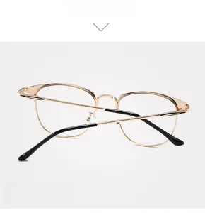 Detail view of golden metal glasses frame with black anti-slip temple tips and fine hinges