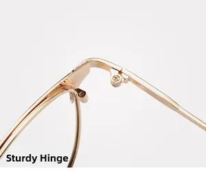 Close-up of the sturdy metal hinge and precision screw detail on the golden glasses frame