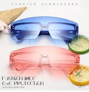 Flat lay of oversized shield sunglasses with blue and orange lenses on marble