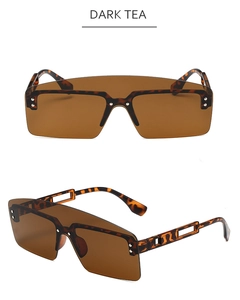 Detail view of oversized tortoise frame sunglasses with dark tea lenses and hollow temples