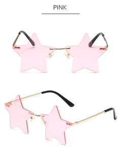 Detail view of star-shaped party sunglasses with pink lenses and gold metal frames