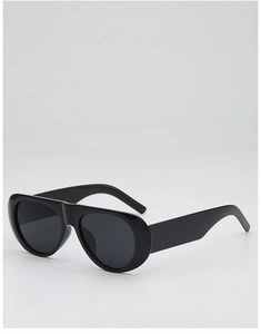 Close-up of black aviator sunglasses with thick resin frames and teardrop lenses