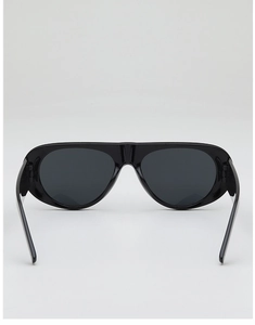 Close-up of sleek black oversized pilot sunglasses with polished one-piece frame design