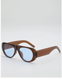 Detail of jelly brown aviator sunglasses with gradient blue lenses and acetate frame