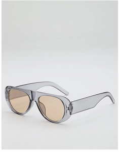 Macro detail of transparent grey aviator sunglasses frame with brown lenses and metal hinge