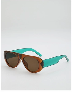 Detail view of stylish color-blocked pilot sunglasses with brown and teal frames