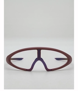 Close-up of futuristic matte burgundy sports glasses with large transparent wrap lens