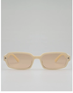 Close-up of cream rectangular sunglasses with orange lenses and silver star accents