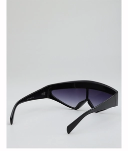 Detail view of the black oversized wrap sunglasses showing temples and gradient lens