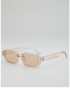 Detail view of transparent amber rectangular sunglasses with model code on inner temple