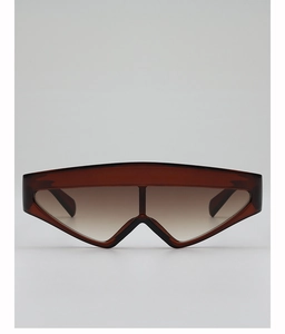 Detail view of large brown gradient lenses and bold flat top frame on oversized sunglasses
