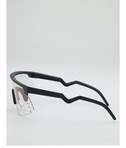 Detail of matte black cycling glasses with ergonomic wavy temples and large wraparound lens