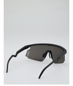 Detail view of black cycling sunglasses showing side ventilation slots and curved temples
