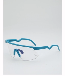 Side view of blue cycling glasses featuring wavy temples and a clear panoramic lens