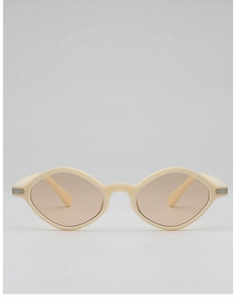 Detail of cream irregular sunglasses with silver metal accents and light brown lenses