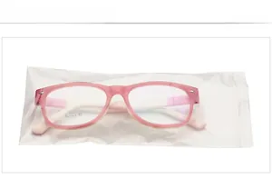 Detailed view of pink candy-colored kids glasses frame in professional packaging