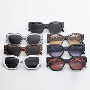 Flat lay of cat-eye sunglasses in various colors including black and leopard print