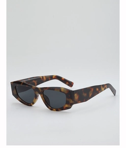 Close-up of retro tortoiseshell sunglasses with dark gray lenses and polygon frame
