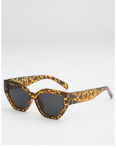 Detail of trendy leopard print cat-eye sunglasses featuring thick temples and dark lenses
