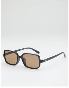 Close-up of retro square sunglasses featuring brown lenses and silver rivet details
