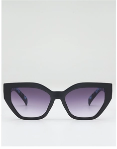 Detail of chunky cat-eye sunglasses with purple gradient lenses and marble patterned temples