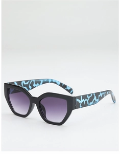 Cat eye sunglasses detail with purple gradient lenses and blue patterned temples