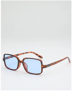 Detail view of tortoiseshell square frame sunglasses with blue lenses and metal rivets