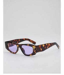 Detail of tortoiseshell patterned thick frame sunglasses with purple tinted lenses