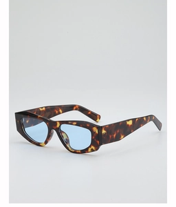 Detail of tortoise shell geometric sunglasses with light blue lenses and thick frame