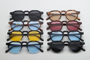 Detailed macro shot showing 3977 size specifications on retro round frame sunglasses