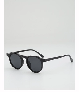 Detail of round sunglasses featuring a unique wavy frame and dark gradient lenses