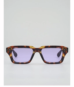 Detail of tortoise frame sunglasses with purple lenses and metallic rivet accents