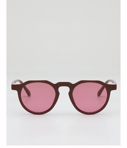 Front view of retro round sunglasses with dark red frames and pink gradient lenses