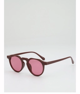 Detailed side view of vintage round sunglasses with red frames and gradient pink lenses