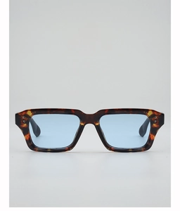 Detail of vintage tortoise frame sunglasses with blue lenses and silver rivet accents
