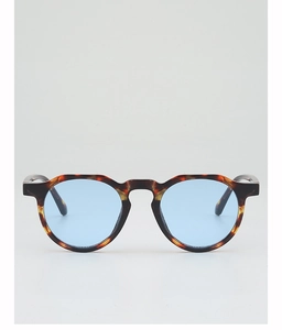 Detail of classic tortoise shell textured frame and light blue lenses on retro sunglasses