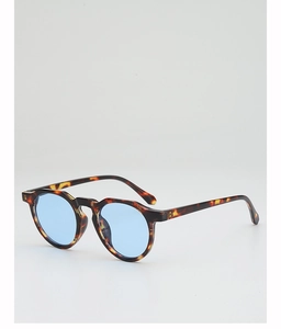 Detail view of round sunglasses with gradient blue lenses and tortoise shell frames
