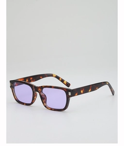 Detail of tortoise shell square sunglasses with silver rivets and purple lenses