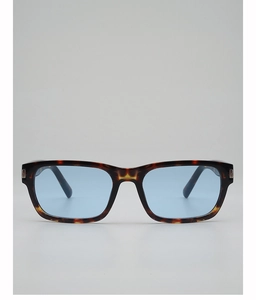 Detail of tortoise frame sunglasses with light blue lenses and silver metal accents