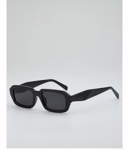 Detail shot of black thick-frame rectangular sunglasses with dark grey lenses in studio setting