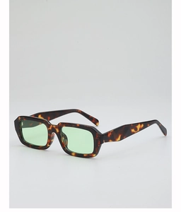 Detail view of tortoiseshell rectangular sunglasses with light green tinted lenses